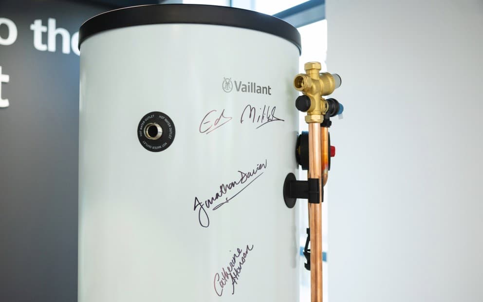 Valiant water heater featuring a three autographs on its surface.