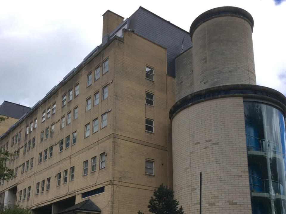 A towering structure with a distinctive chimney, showcasing its height and architectural design.