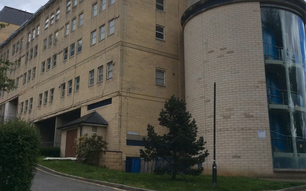 A towering structure with a distinctive chimney, showcasing its height and architectural design.