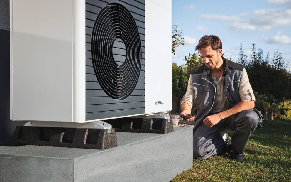 installer doing some work on a aroTHERM plus heat pump