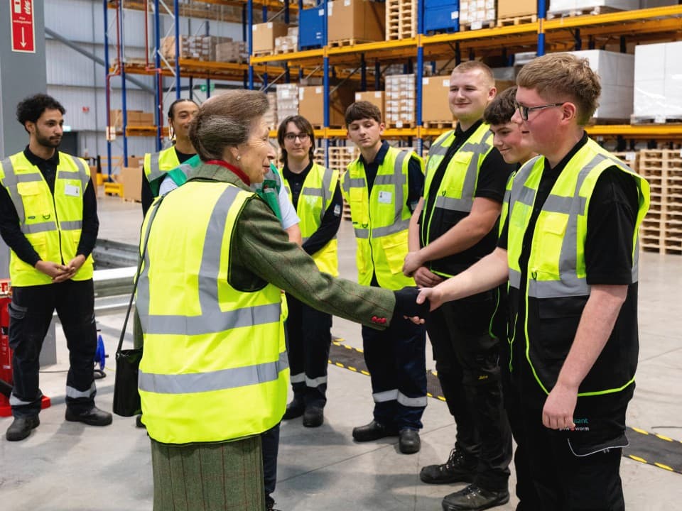 HRH Princess Anne shaking hands with Vaillant workers and engaging in conversation.