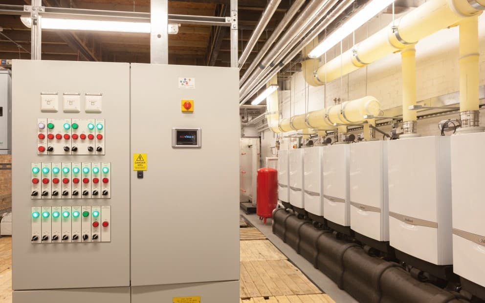 A room filled with multiple electrical panels and valves, showcasing industrial equipment and infrastructure.