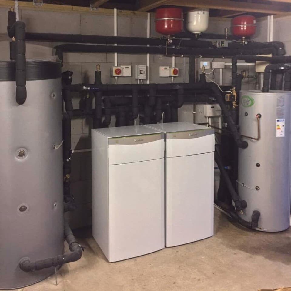 Two ground source heat pumps units inside a boiler room.