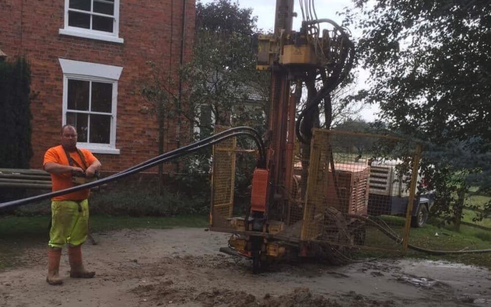 Man standing next to a large piece of machinery