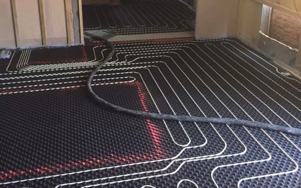 Underfloor heating installation taking place with large wires running across the floor
