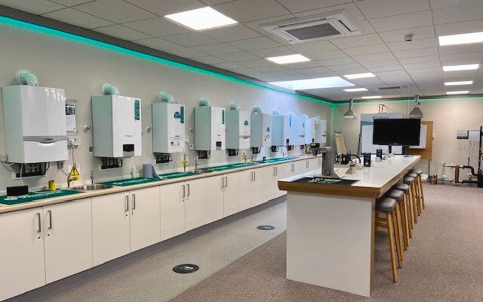 9 boilers on a wall with a cupboard underneath