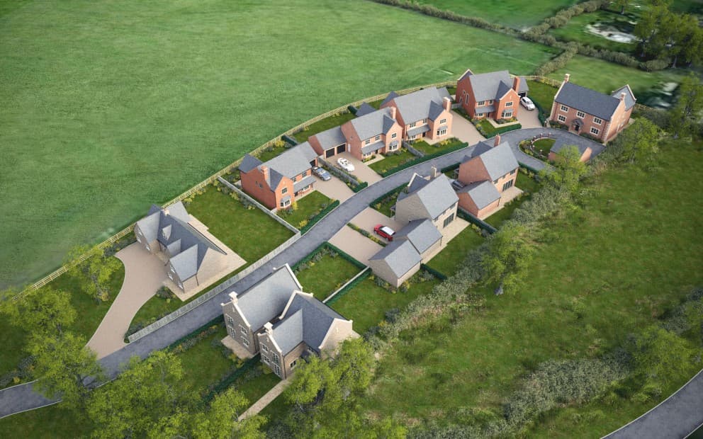 Aerial view of a housing development with grass surrounding the estate.