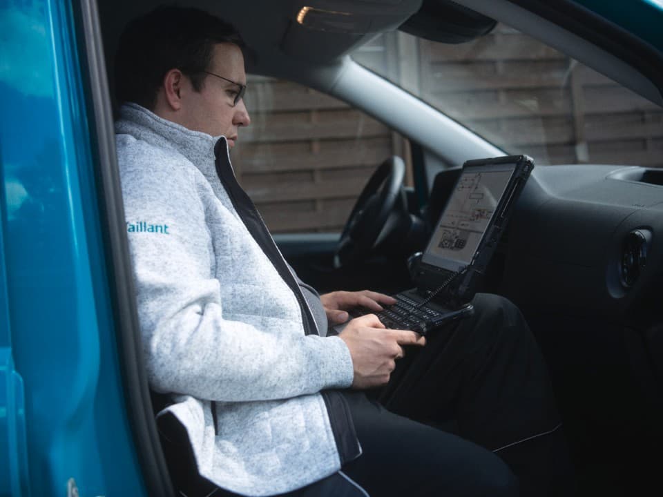 Installer sits in a car